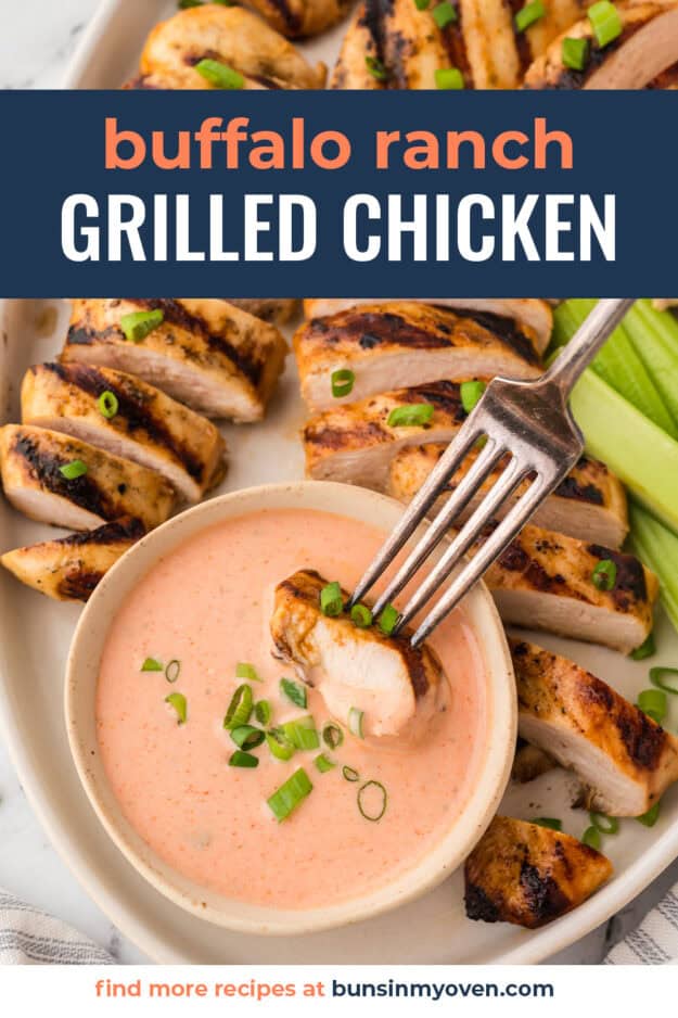Piece of buffalo ranch grilled chicken being dipped in spicy ranch.