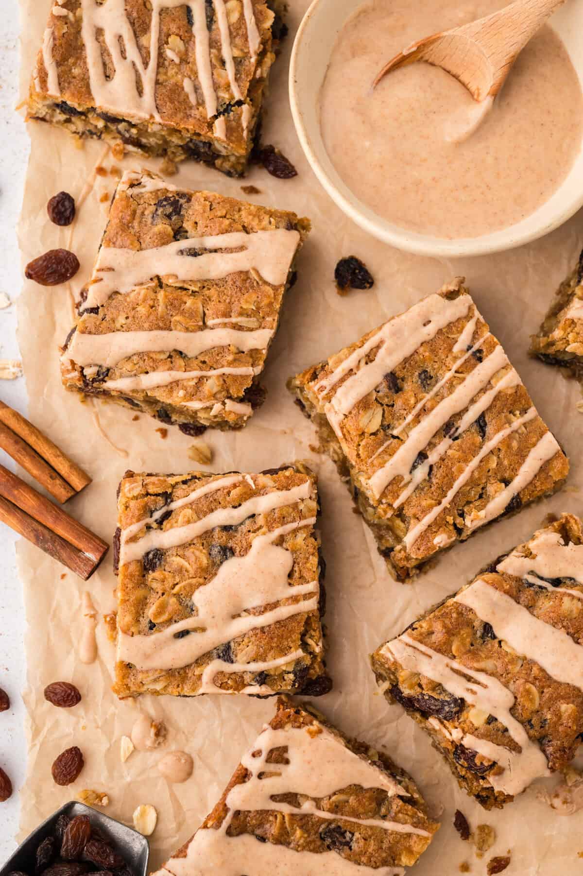 Oatmeal raisin bars with brown butter glaze drizzled over the top,.