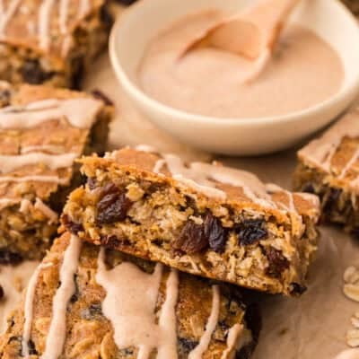 Oatmeal raisin cookie bars topped with brown butter glaze.