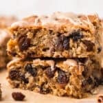 Stack of oatmeal raisin cookie bars on counter.