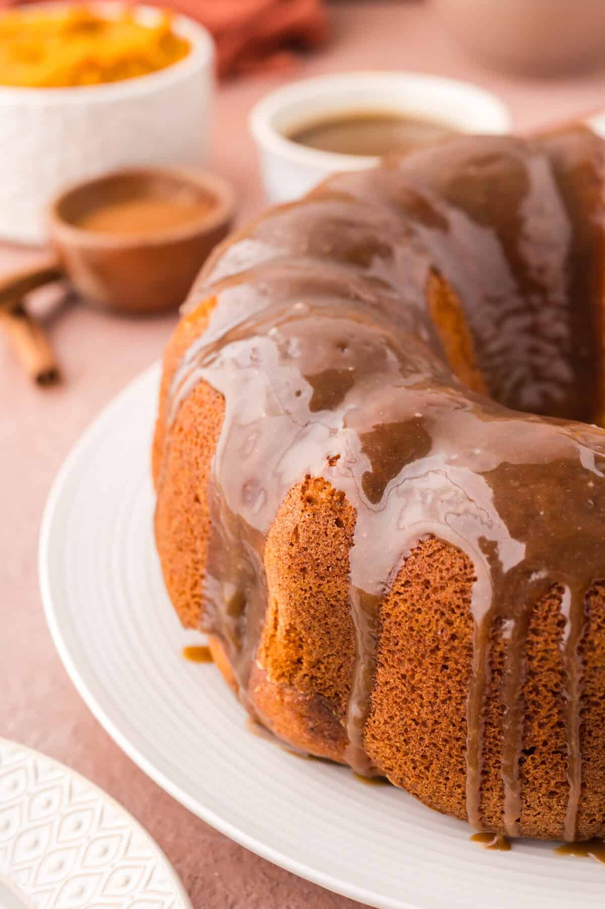 Brown sugar glazed pumpkin cake on cake stand.