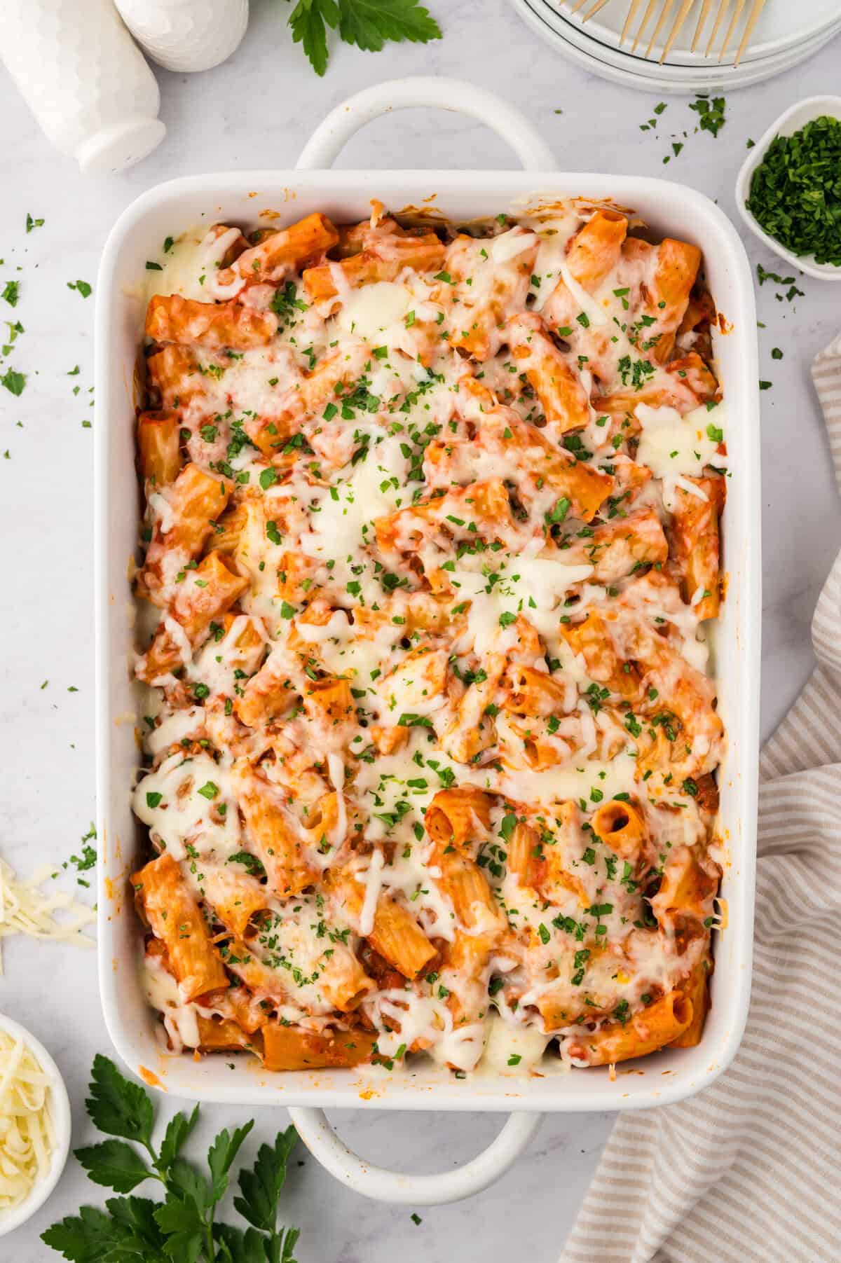 Cream cheese baked rigatoni in white baking dish.