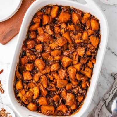 White casserole dish filled with candied yams recipe.