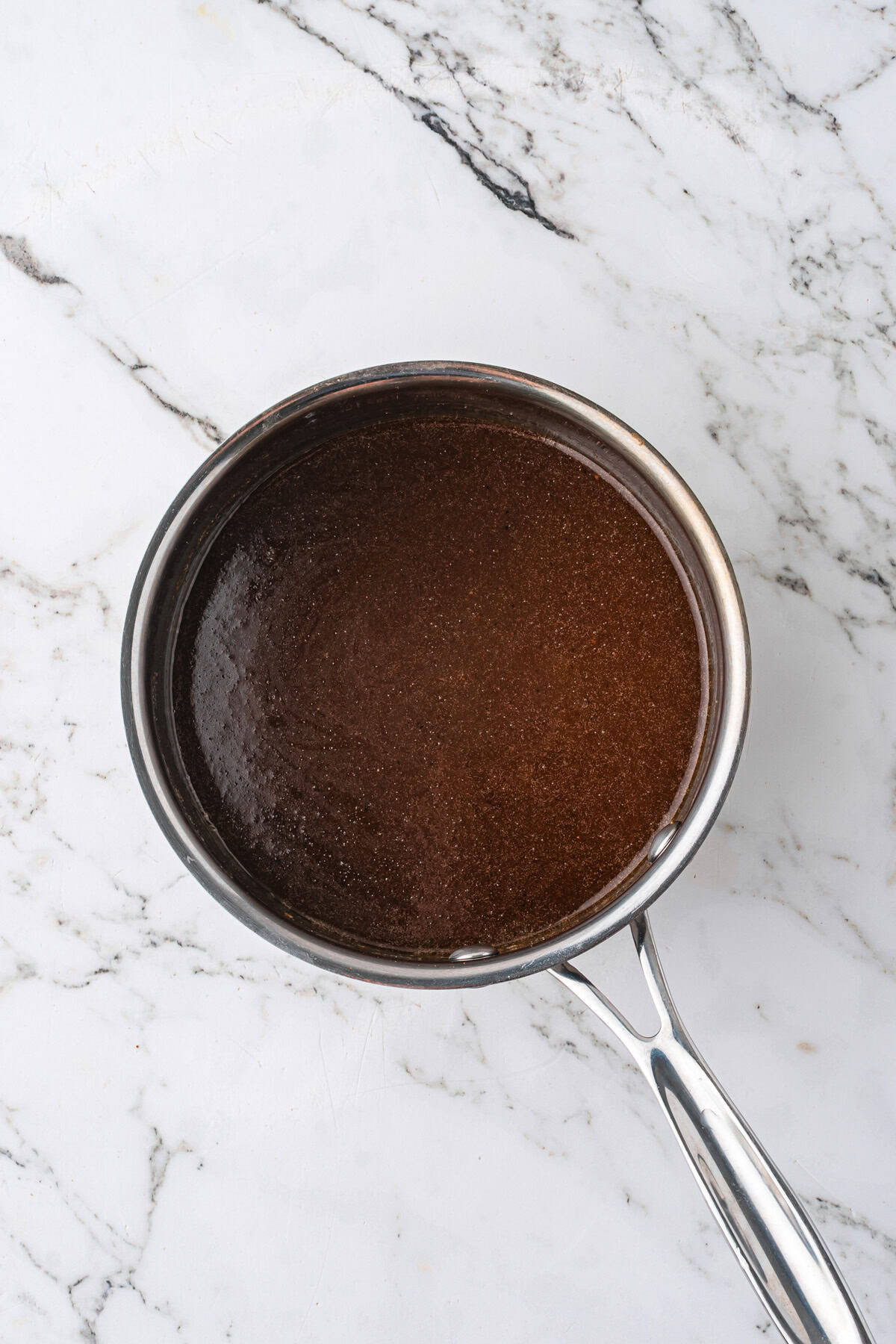 Sauce for making canned yams in saucepan.