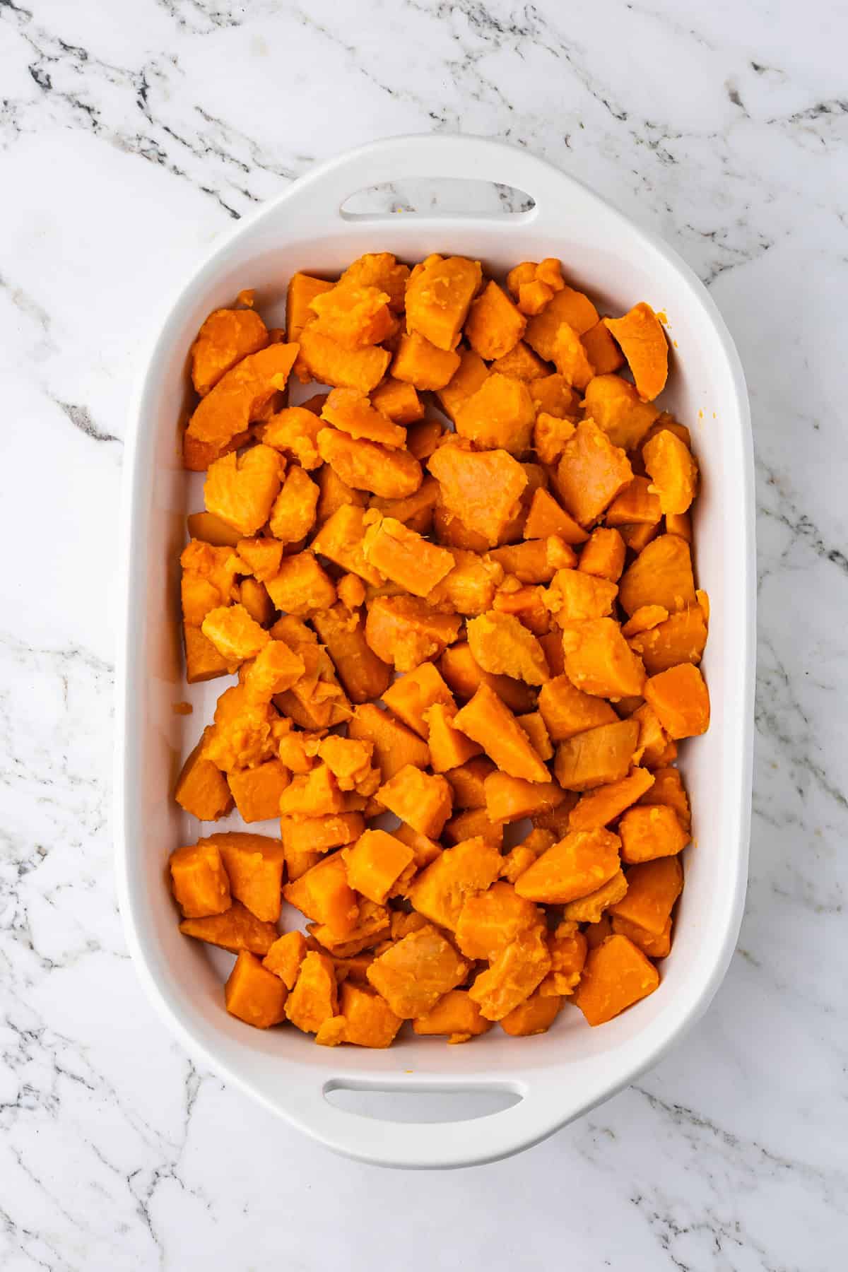 Canned yams in white casserole dish.