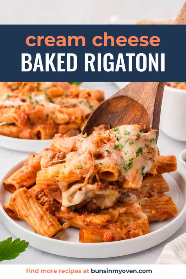 Cheesy baked rigatoni being scooped onto plate.