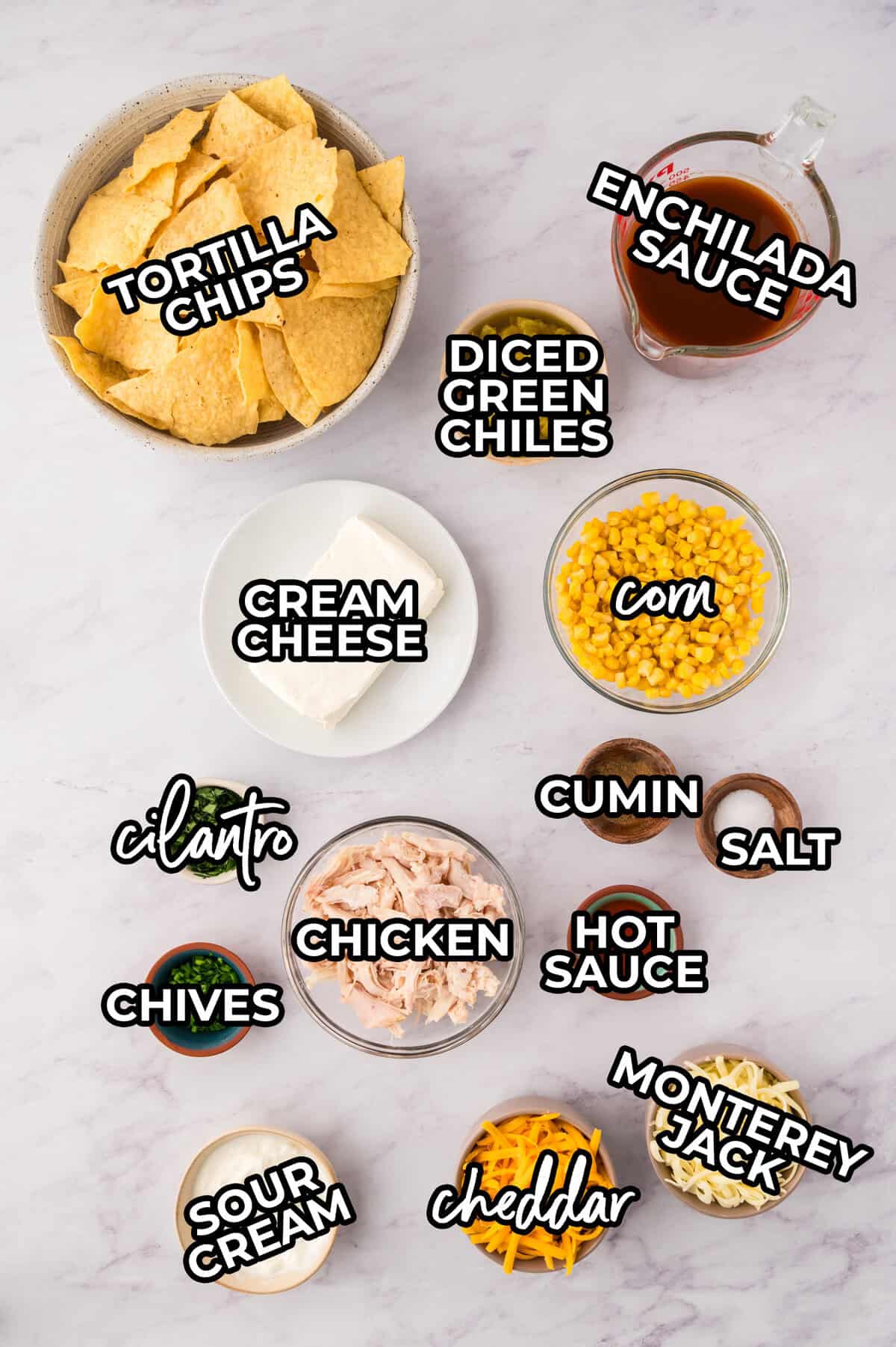 Ingredients for chicken enchilada dip recipe laid out on counter top.
