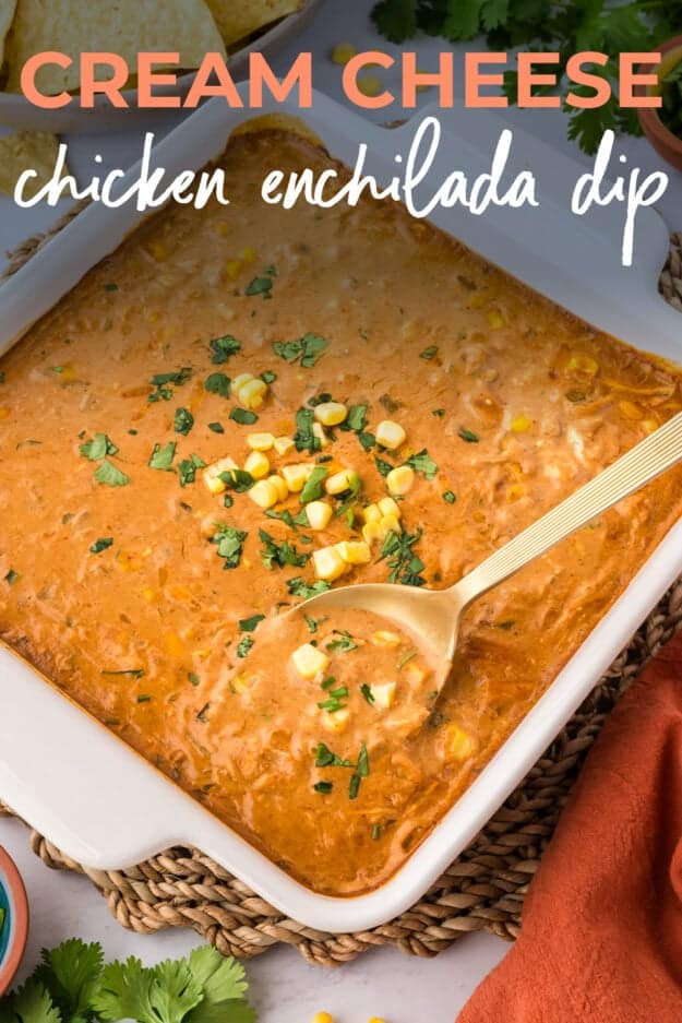 Chicken enchilada dip in baking dish with gold spoon.